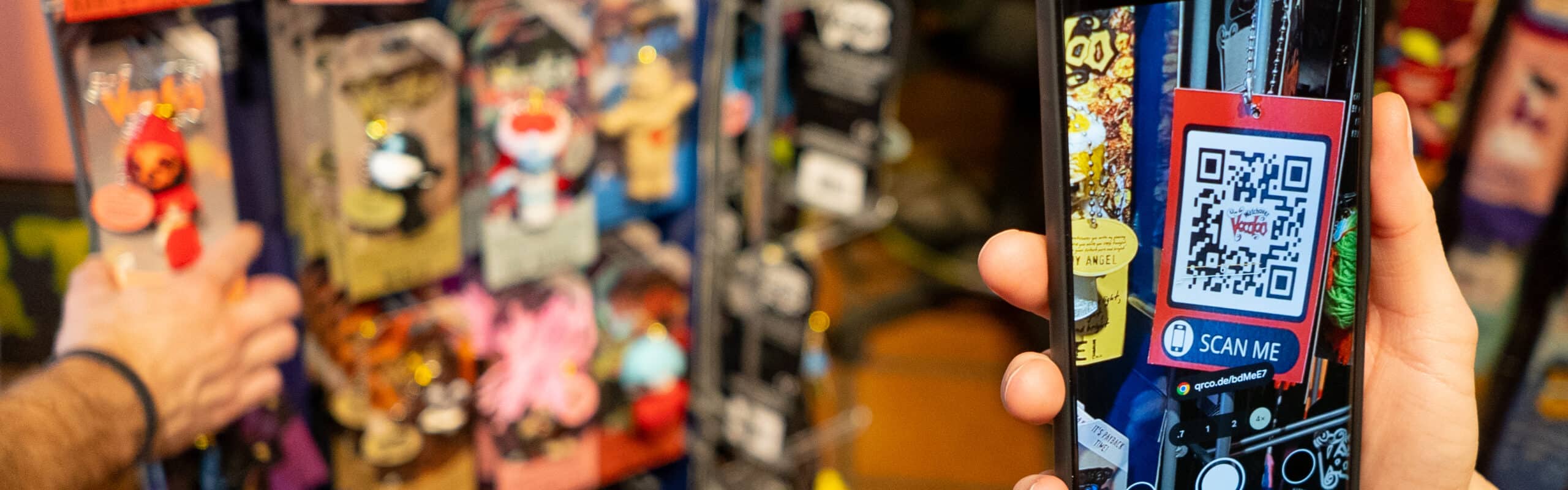 a hand holding a phone scanning the voody AR QR code